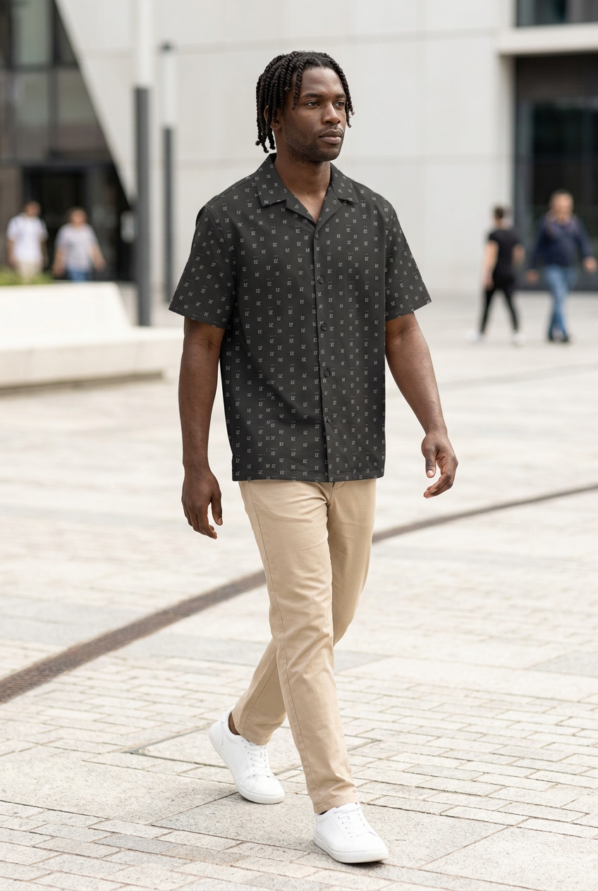 Black model walking across a modern pedestrian plaza