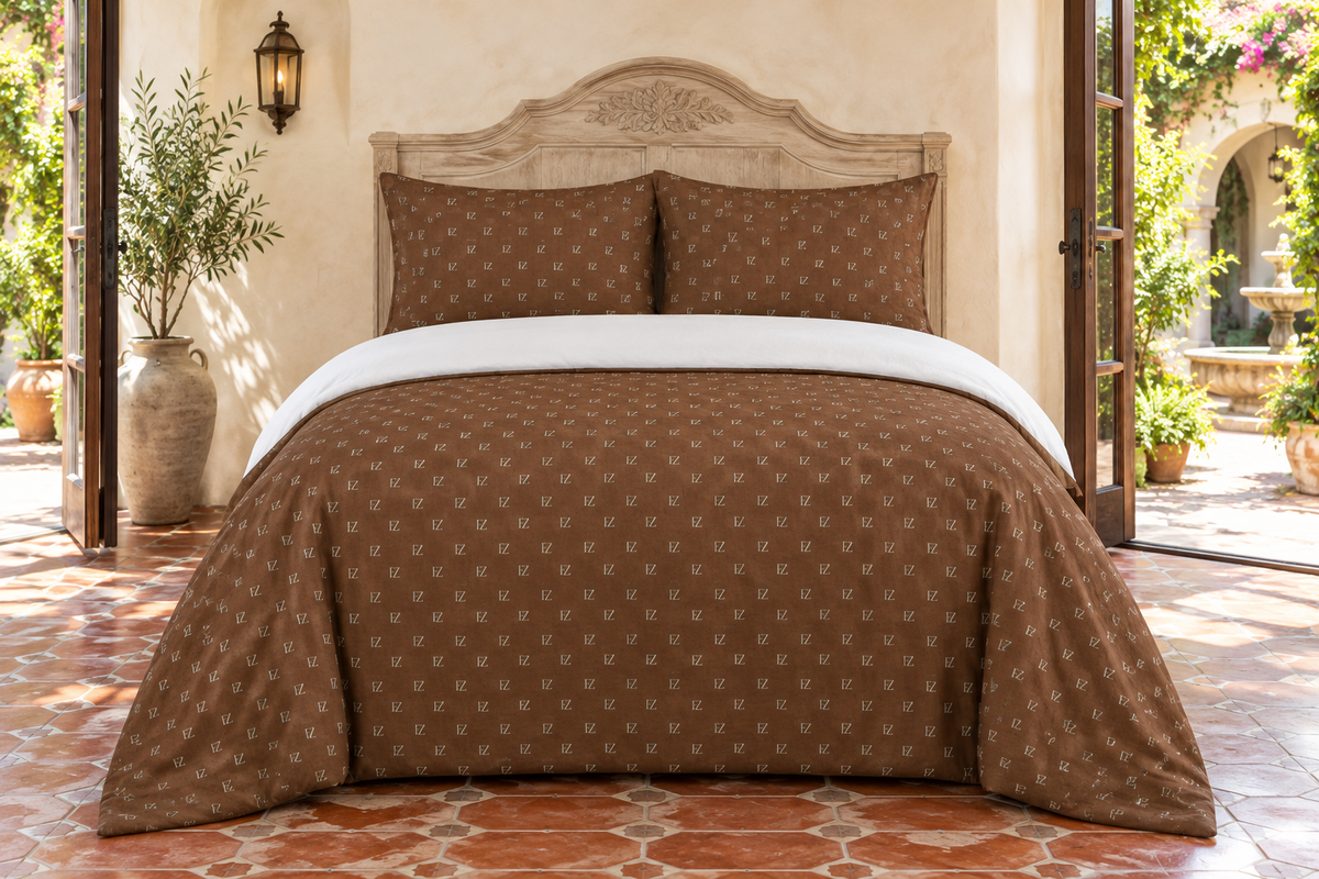 Brown monogram bedding in a dusty-blue contemporary bedroom