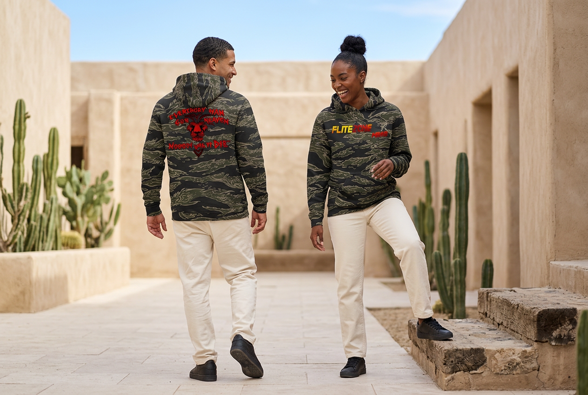 Playful courtyard scene with a Black woman showing the hoodie front and a Latino man showing the back