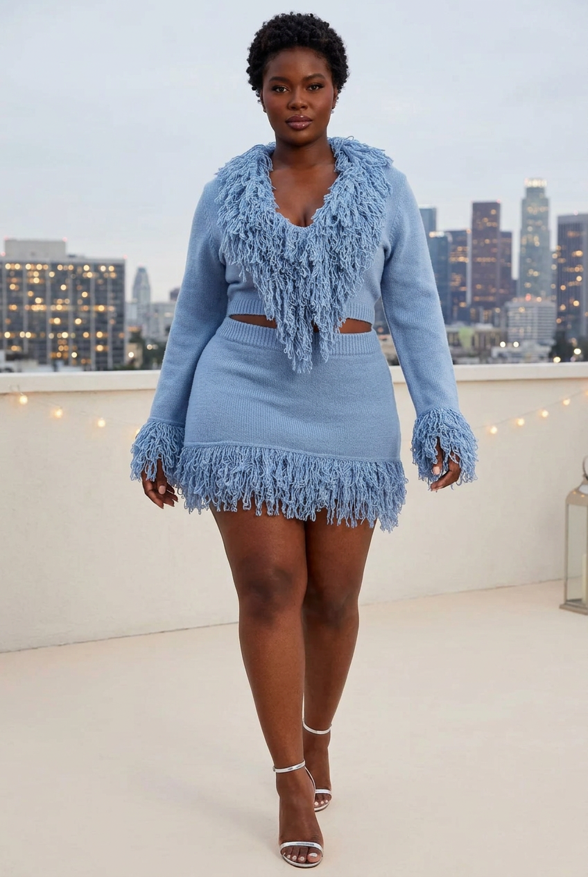 Plus-size model in blue knit suit at a rooftop party