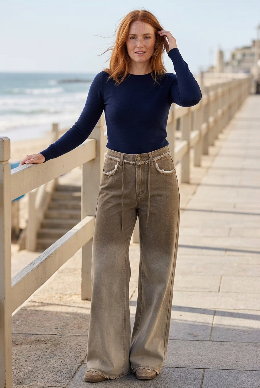 White model beside a seaside promenade railing