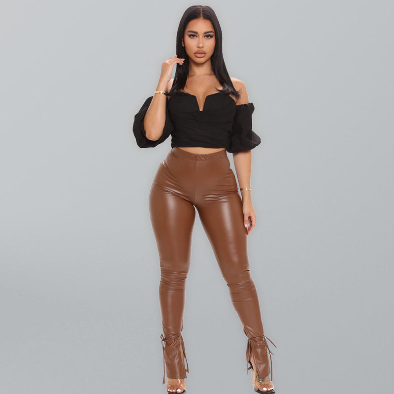 women’s vegan leather pants with adjustable suspender straps and slit